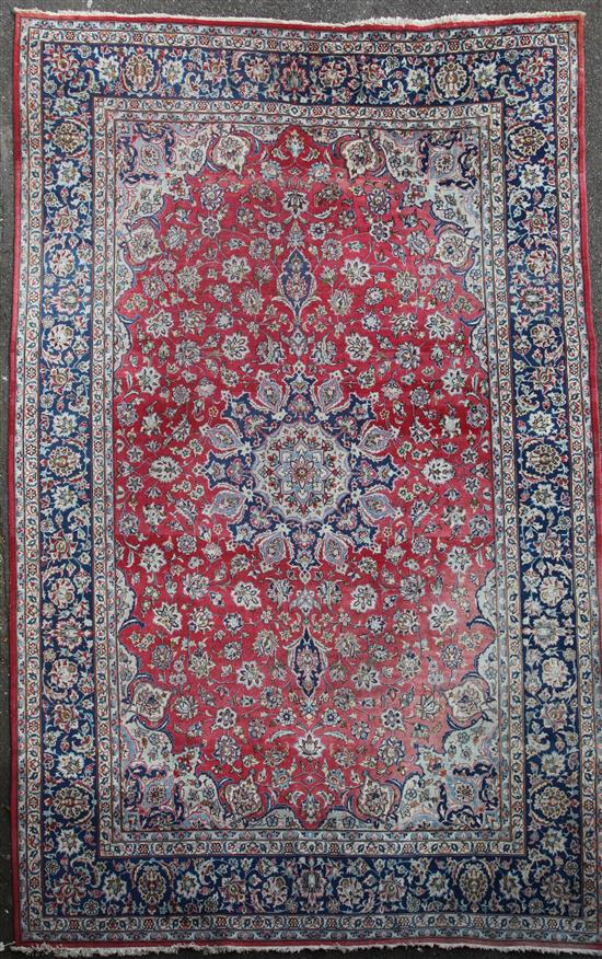 A large Isfahan red ground carpet, 14ft by 9ft 10in.